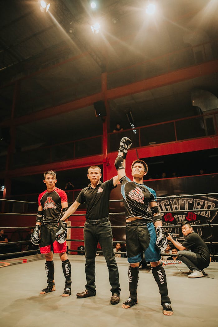 Crafting Captivating Headlines: Your awesome post title goes here Mixed martial arts match with the winner announced in a boxing ring under bright lights.